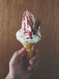 Close-up of hand holding ice cream