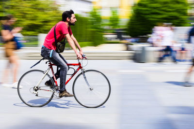 Side view of man riding bicycle