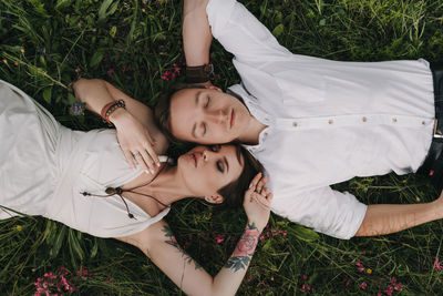 High angle portrait of woman relaxing on field