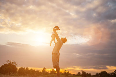 Side view of man playing against sky during sunset