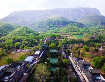 High angle view of trees and buildings against sky