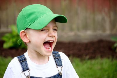 Close-up portrait of playful child outdoors