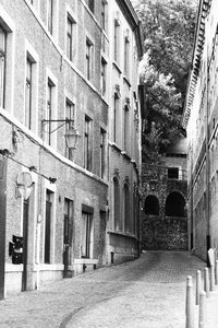 Narrow street amidst old buildings in city