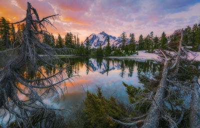 Scenic view of lake against sky at sunset