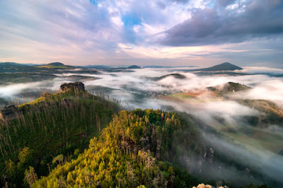 Scenic view of waterfall against sky during sunset