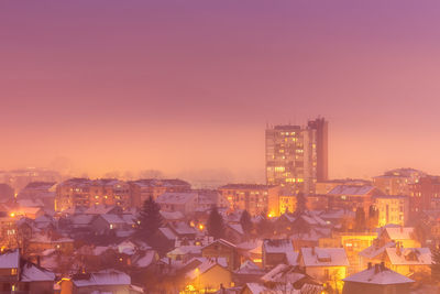 High angle view of illuminated cityscape against sky during sunset