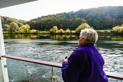 Rear view of woman looking at lake