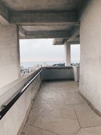 Bridge over sea against buildings