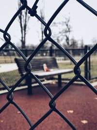 Close-up of chainlink fence against sky