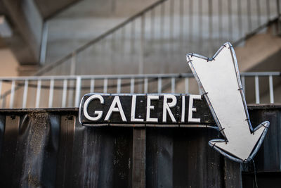 Close-up of information sign on gate