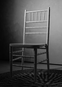 Empty chairs and table against wall at home