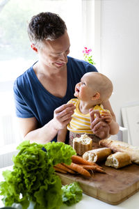 Father with baby in kitchen