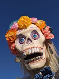 Close-up of statue against blue sky