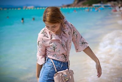 Young woman standing at beach