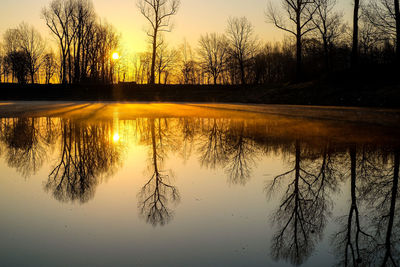 Scenic view of lake against sky at sunset