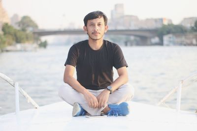 Portrait of young man sitting outdoors