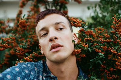 Close-up of thoughtful young man by berry fruits