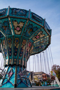 Low angle view of ferris wheel against buildings