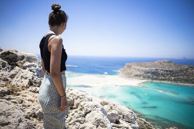 Girl with rear view over balos beach, crete