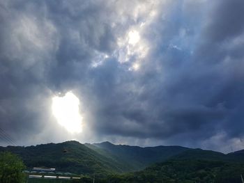 Scenic view of mountains against storm clouds