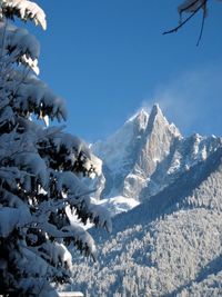 Scenic view of snowcapped mountains against cloudy sky