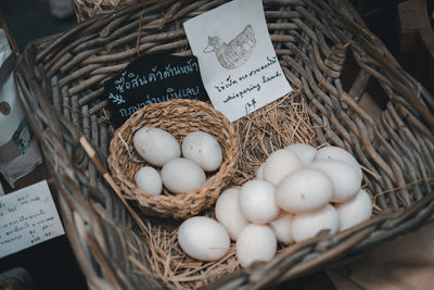 High angle view of eggs in basket for sale at market