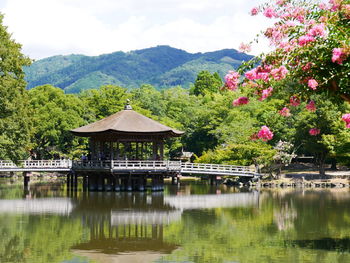 Scenic view of lake by mountain against sky