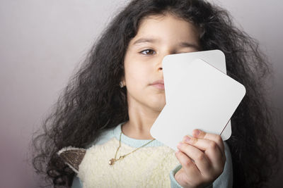 Portrait of young woman holding paper