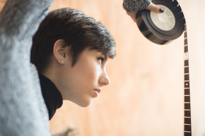 Close-up of young woman with film reel