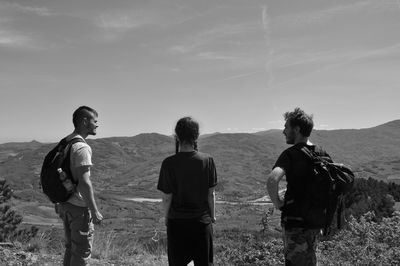 People standing on landscape against sky