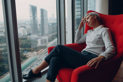 Midsection of man looking through window