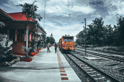 Railroad tracks amidst trees against sky