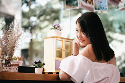 Portrait of beautiful woman standing at home