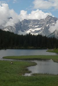 Scenic view of lake and mountains against sky