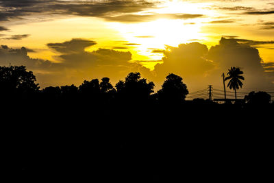 Silhouette trees against sky during sunset