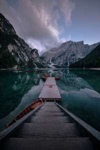 High angle view of boats moored at harbor in lake against mountains