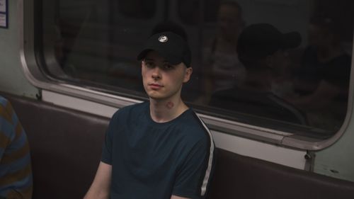 Portrait of man standing in train