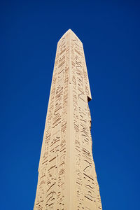 Low angle view of monument against blue sky