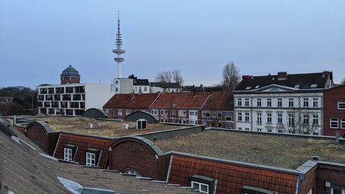 Buildings in city against clear sky