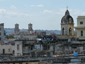 View of cityscape against cloudy sky