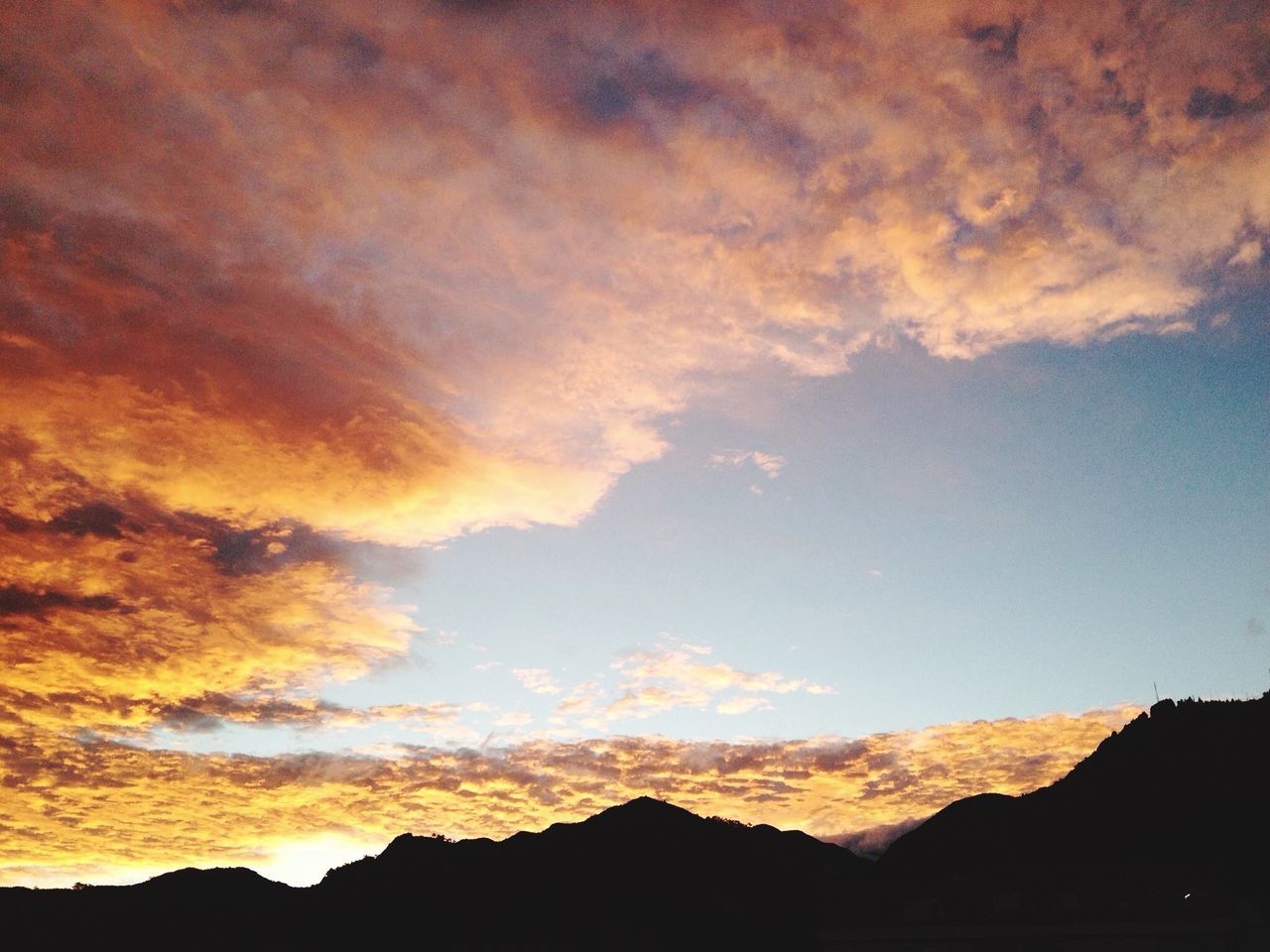 silhouette, sunset, scenics, sky, tranquil scene, tranquility, beauty in nature, mountain, cloud - sky, nature, landscape, idyllic, cloud, orange color, mountain range, outdoors, dusk, majestic, non-urban scene, no people