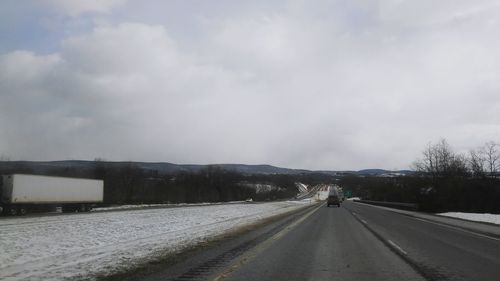 Road against cloudy sky