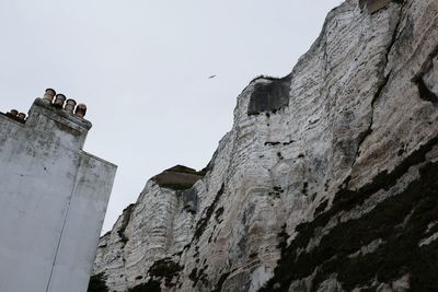 Low angle view of rocks against clear sky