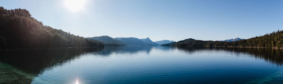 Scenic view of lake and mountains against clear sky