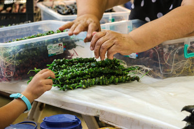 Midsection of man preparing food at market