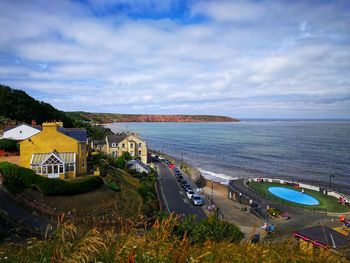 High angle view of sea and buildings against sky