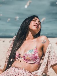 Young woman with long hair relaxing at beach