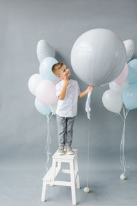 Gender reveal party. a four-year-old child holds a balloon in his hands to find out the gender