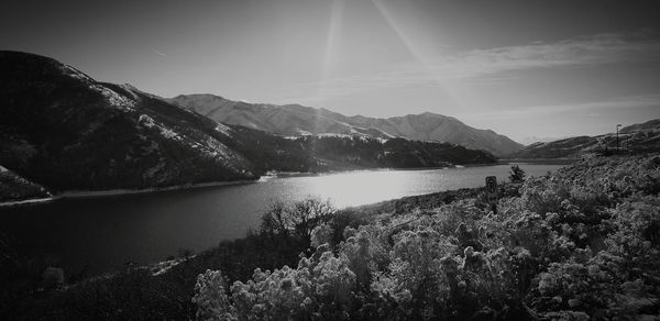 Scenic view of lake and mountains against sky