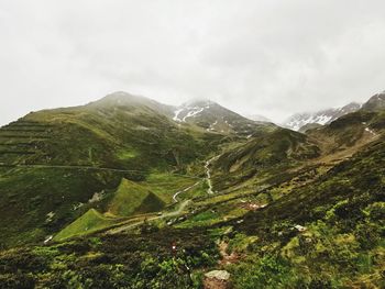 Scenic view of green mountains against sky